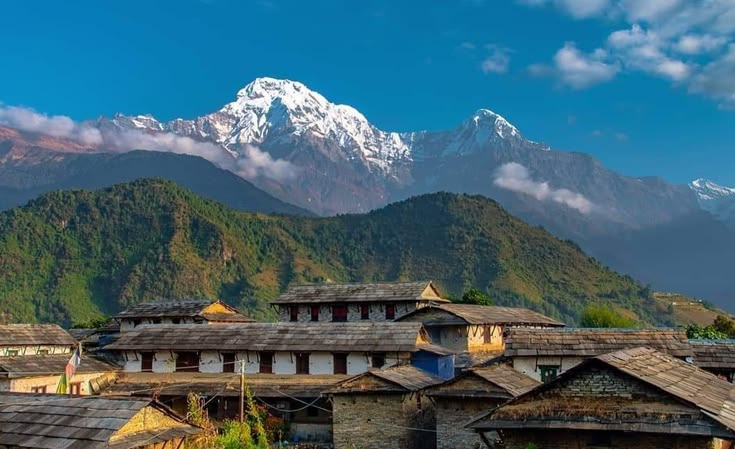 Terraced fields and stone houses of Ghandruk village below the Annapurna peaks